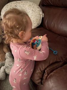 Toddler playing with Montessori Pull String Activity