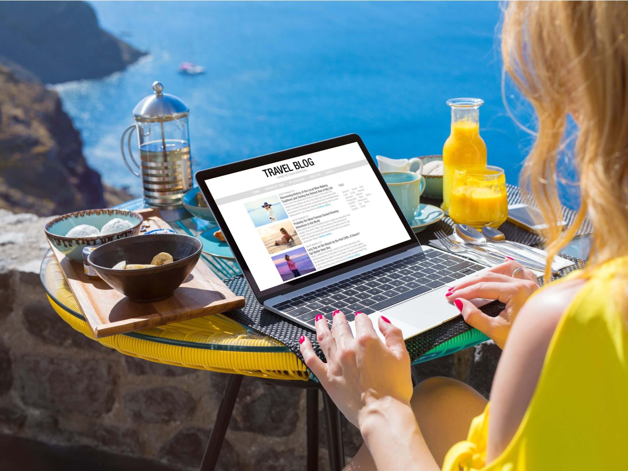 woman blogging next to beach